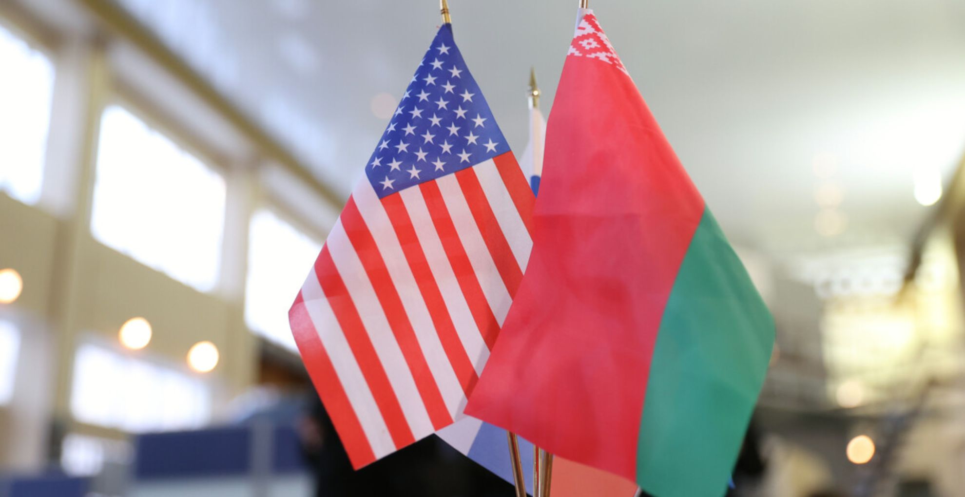 флаги беларуси и сша стоят на столе