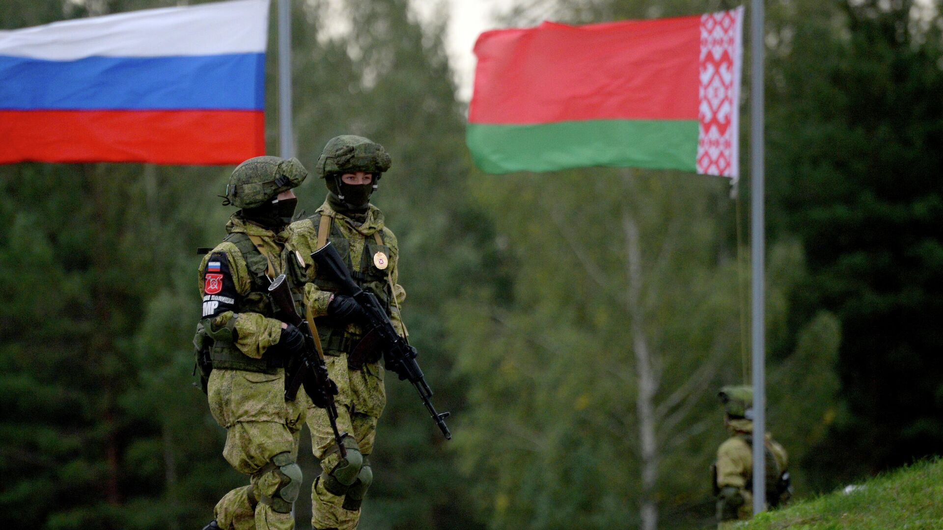 военные Беларуси и России на фоне флагов государств