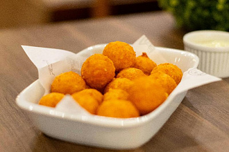 Хрустящая корочка и тягучая начинка: как быстро приготовить сырные шарики дома